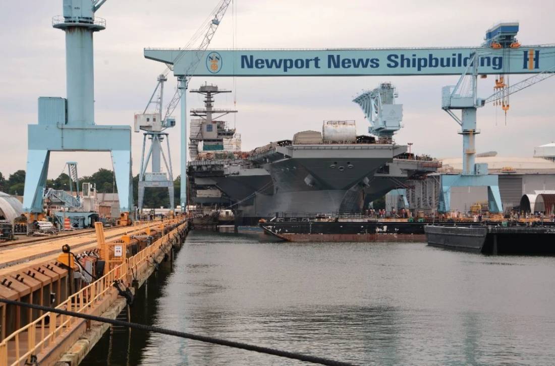 Aircraft carrier in drydock at a U.S. shipyard, the scale of structure where laser tracker dimensional control replaces tape and transit