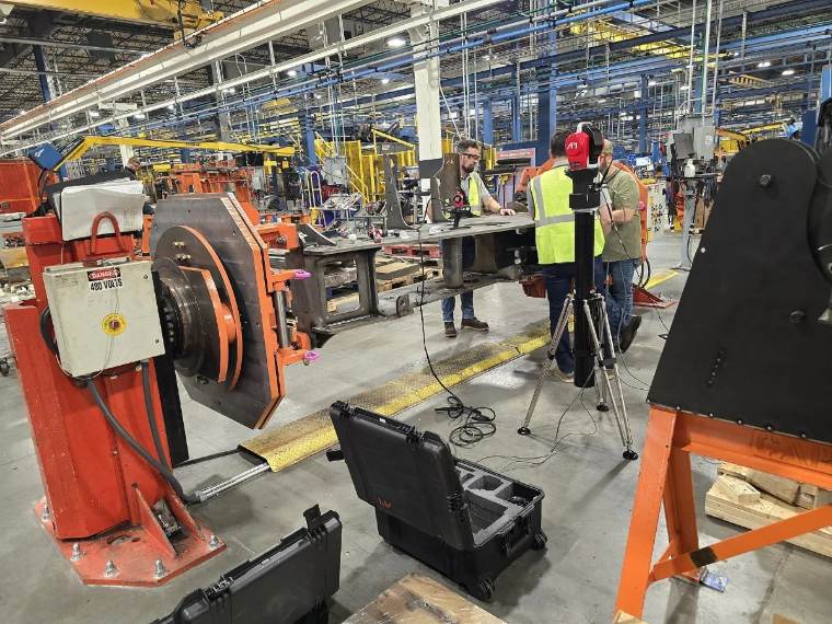 Tier 1 supplier inspecting a large fixtured part on the shop floor to meet customer tolerance and reporting requirements